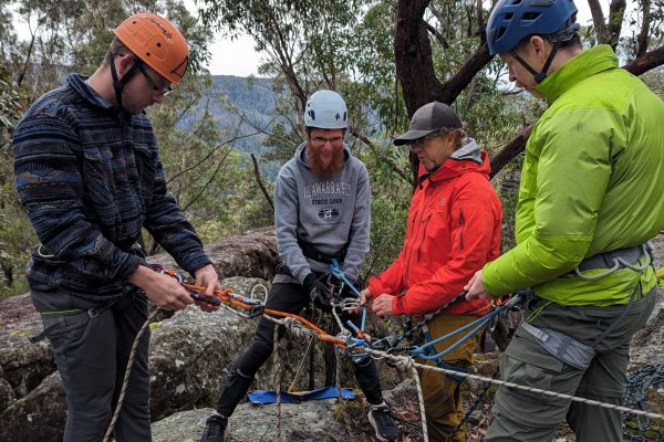 Indoor Climb South Coast: members of a group abseilling session near Nowra preparing for the descent.
